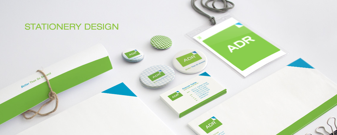 View of ADR's brochure design on buttons, business card, tags, designed by Entermotion, a Wichita web-design studio.