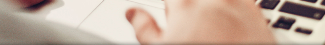 Blurred image of a man typing on a keyboard.