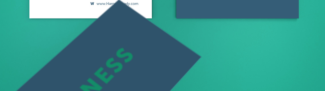 The front of a Harness business card in dark blue with green text.