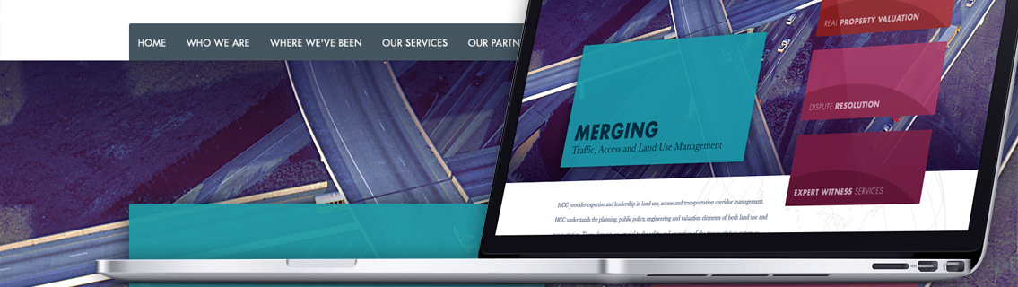 Laptop showcasing Huffman Corridor Consulting website with homepage demo in the background.