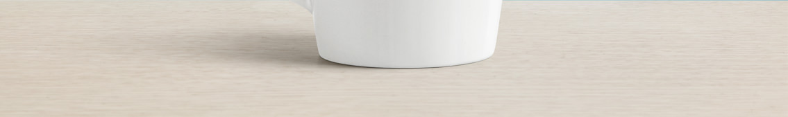 Bottom of a mug on a lightly colored surface.