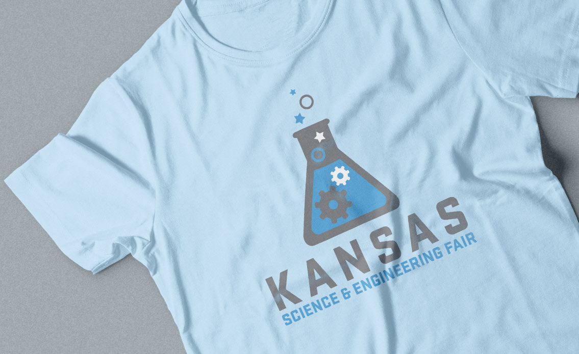 Blue t-shirt with Kansas Science and Engineering Fair logo.