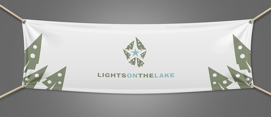 Decorated trees on Lights on the Lake banner.