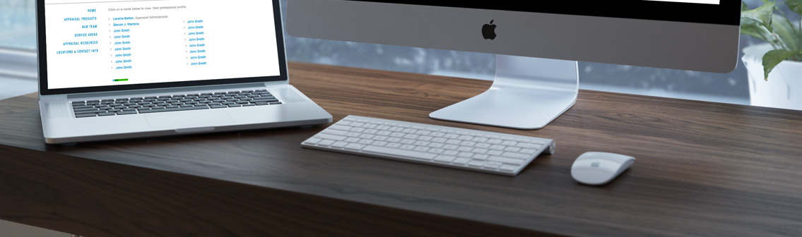A laptop, monitor stand and the bottom slice of a monitor, as well as computer paraphernalia, on top of a desk.
