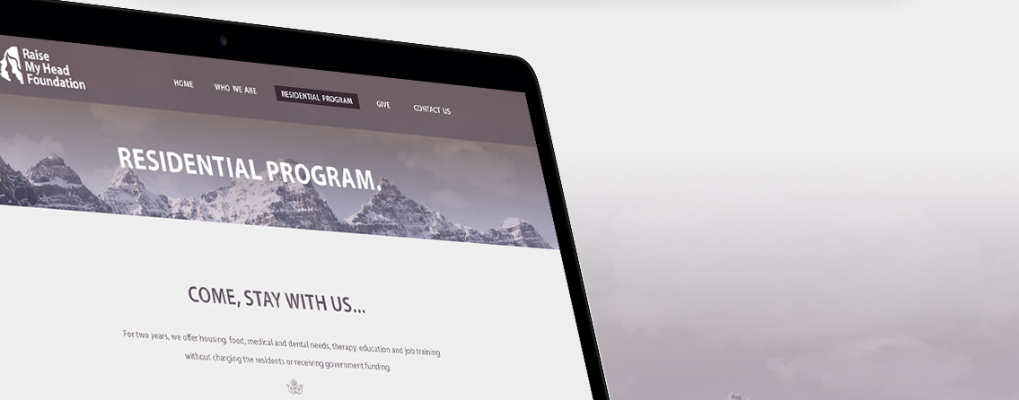 Top half of a MacBook demonstrating the “Raise My Head Foundation” homepage.