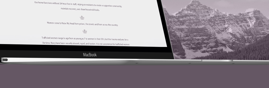 Bottom half of a MacBook demonstrating the “Raise My Head Foundation” homepage.
