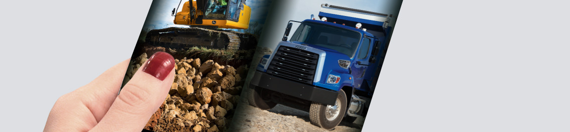 Hand holding brochure showcasing building equipment.