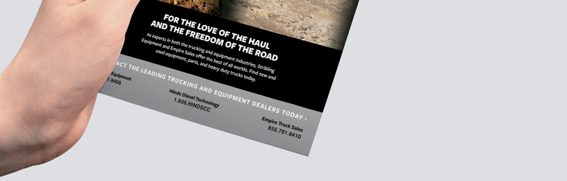 Hand holding brochure with text reading, “For the love of the haul and the freedom of the road.”