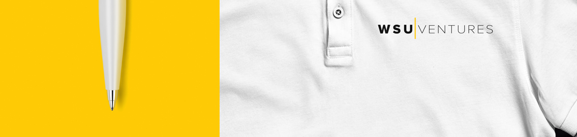 The tip of a pen and the chest section of a shirt with the WSU Ventures’ logo above the breast.