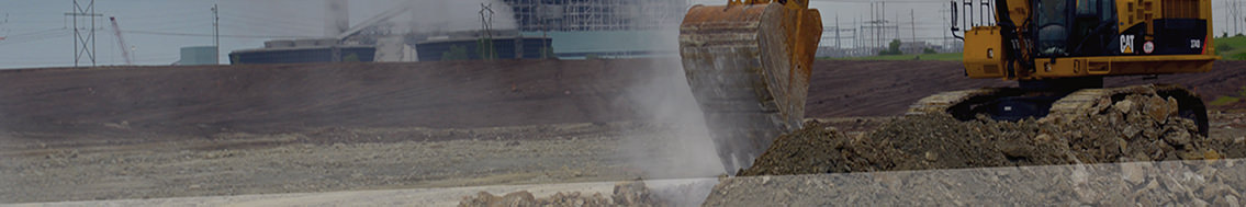 Close up of CAT machine digging dirt on worksite.