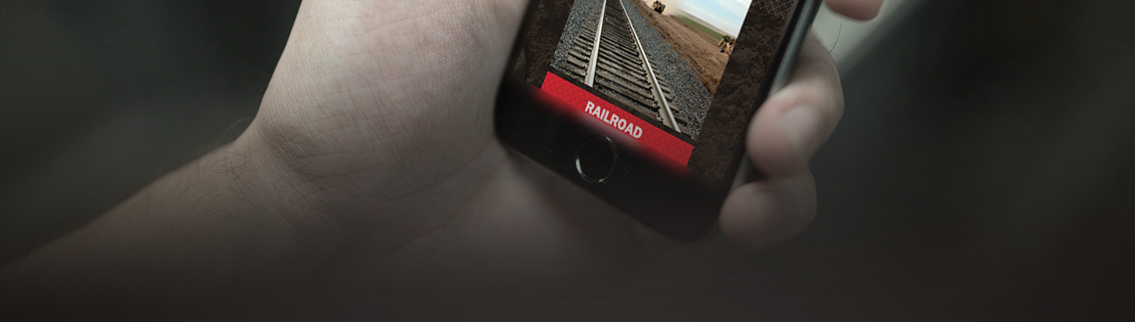 Hand holding mobile phone displaying Bergkamp Construction's website.