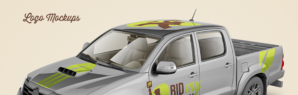 Grey truck with green and brown Bid My Lawn logo on side.