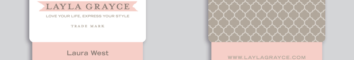 Layla Grayce text over pink ribbon on business card close up.