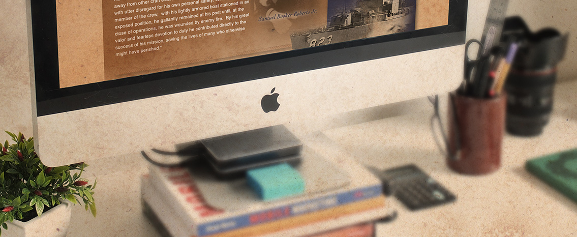 Close-up of laptop featuring SBR page standing on books.