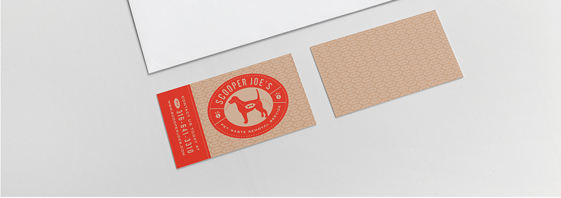 Scooper Joe's logo displayed on business card in front of laptop.