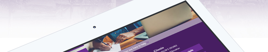 Man writing in front of open computer.