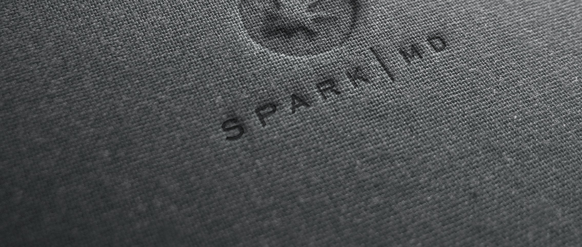 Close view of Spark MD logo.